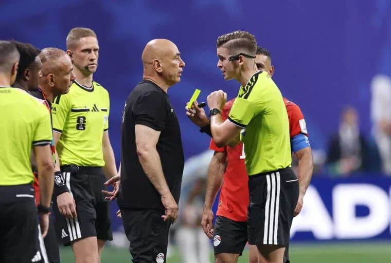 Referee discussing with coaches during match stoppage Referee discussing with coaches during match stoppage