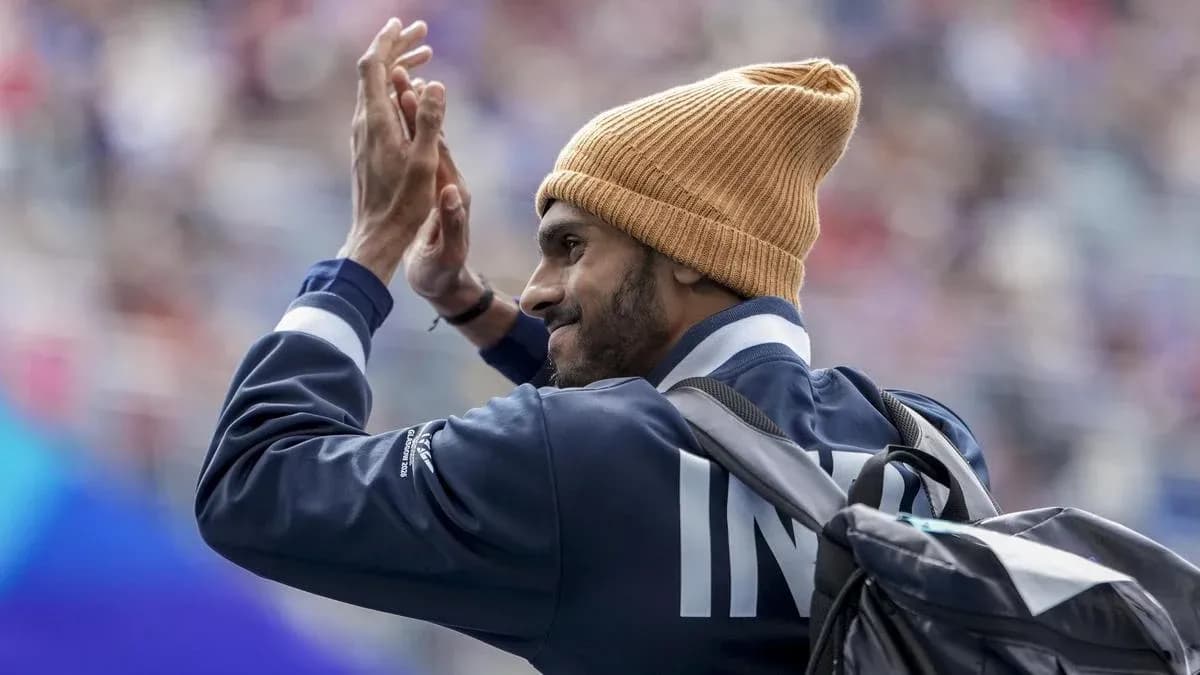 Sportsperson waving while wearing a beanie Sportsperson waving while wearing a beanie