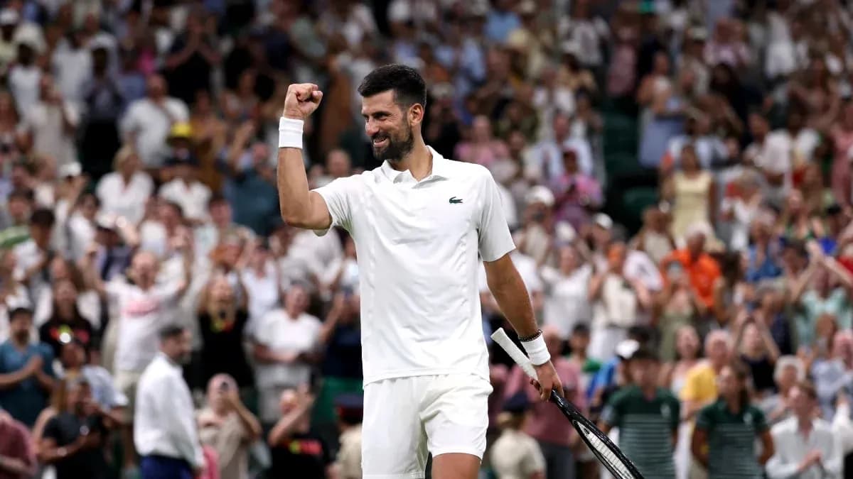 Tennis player celebrating in front of cheering crowd Tennis player celebrating in front of cheering crowd