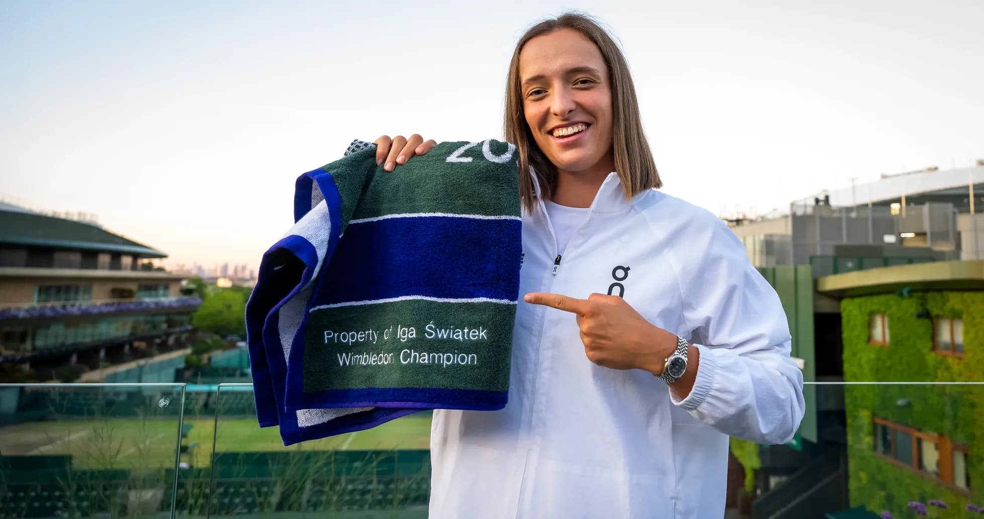 Iga Swiatek holding Wimbledon champion towel Iga Swiatek holding Wimbledon champion towel