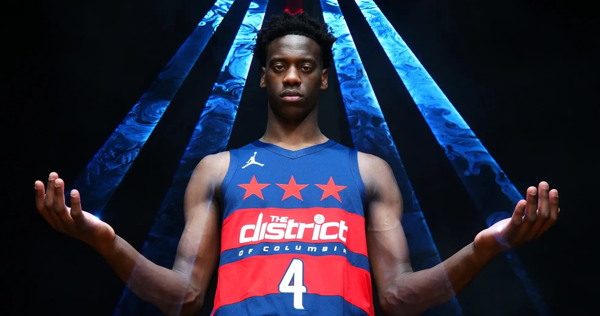 Basketball player posing in jersey with raised arms Basketball player posing in jersey with raised arms