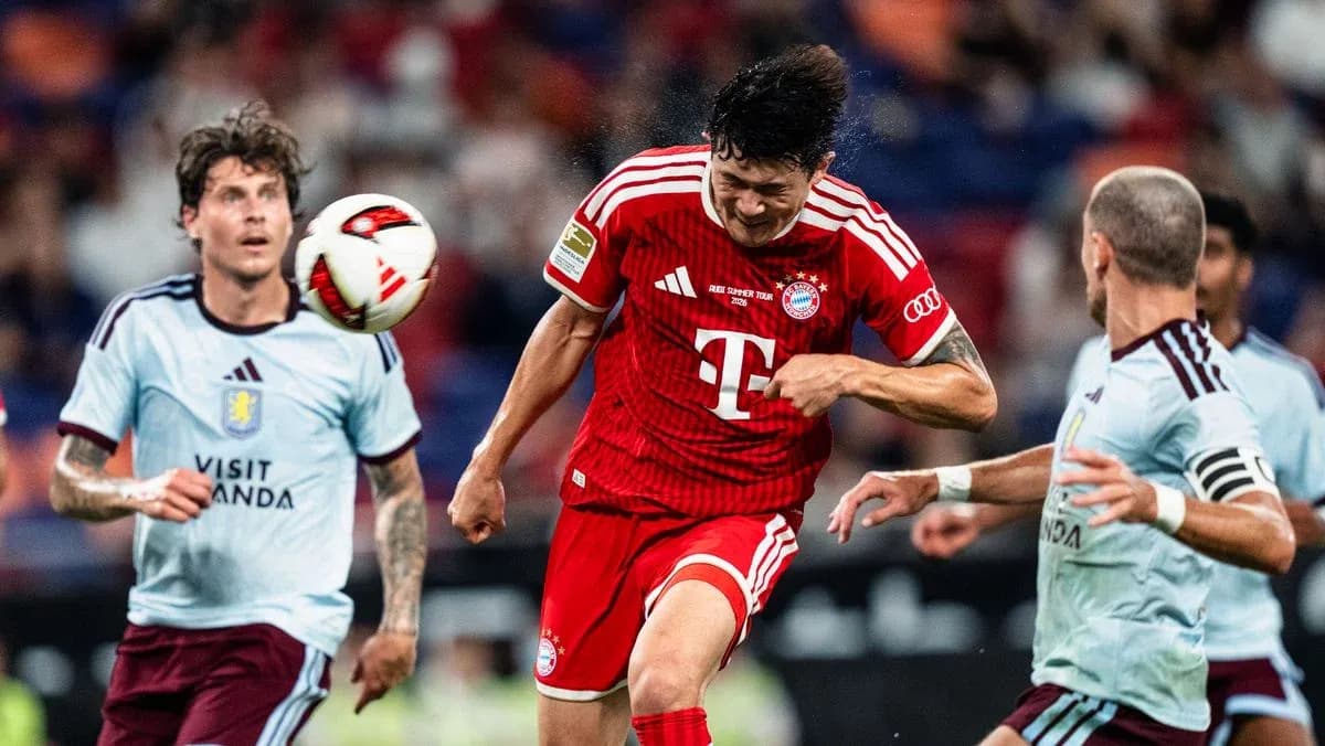 Bayern Munich player heading the ball in match Bayern Munich player heading the ball in match