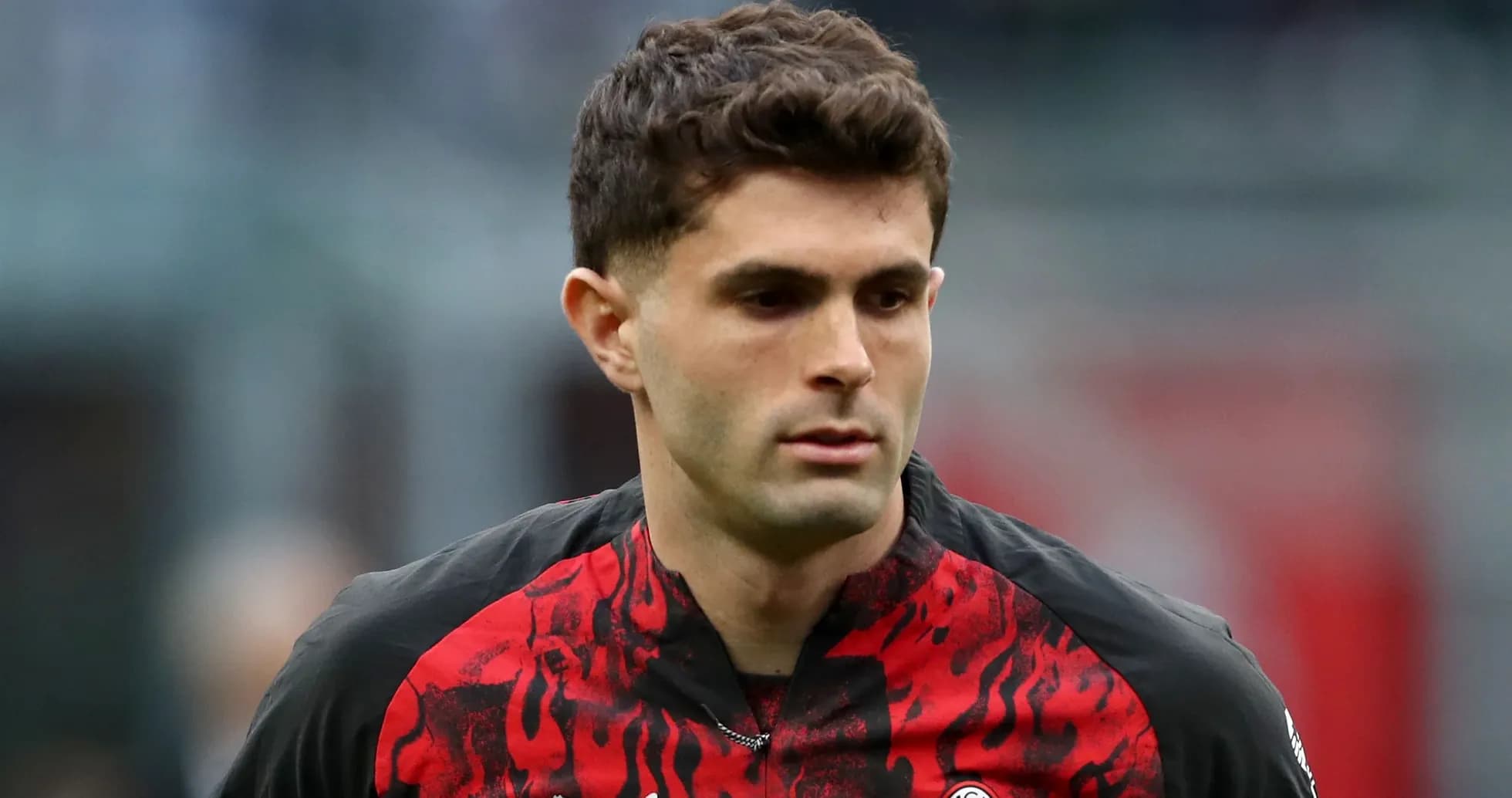 Futbolchi maydonda harakatda, qizil qora forma kiygan Futbolchi maydonda harakatda, qizil qora forma kiygan