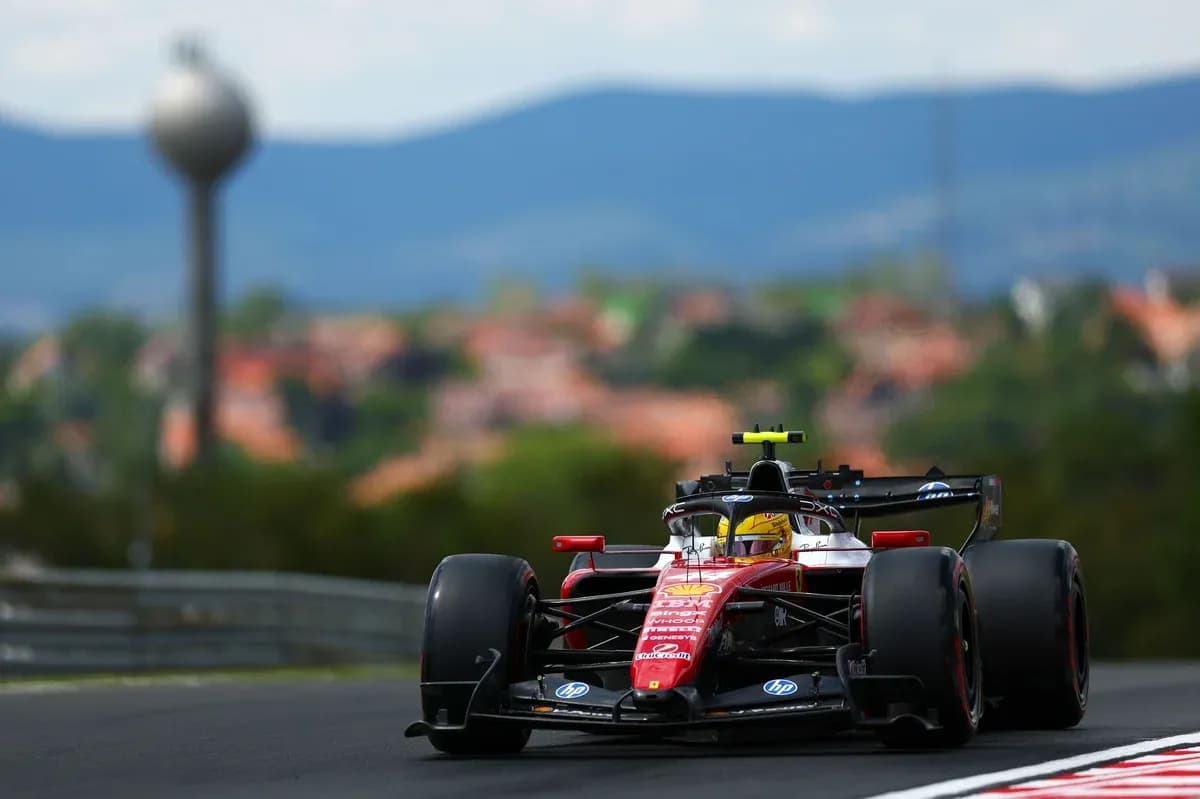 Formula 1 car racing on track with background scenery Formula 1 car racing on track with background scenery