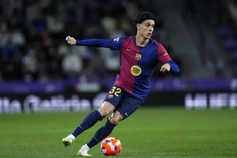 Barcelona player dribbling the ball on field Barcelona player dribbling the ball on field