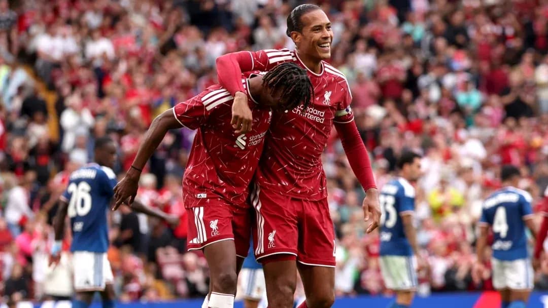 Liverpool players celebrating a goal on the pitch Liverpool players celebrating a goal on the pitch