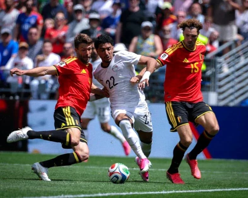 Egyptian player challenged by two Belgian defenders Egyptian player challenged by two Belgian defenders