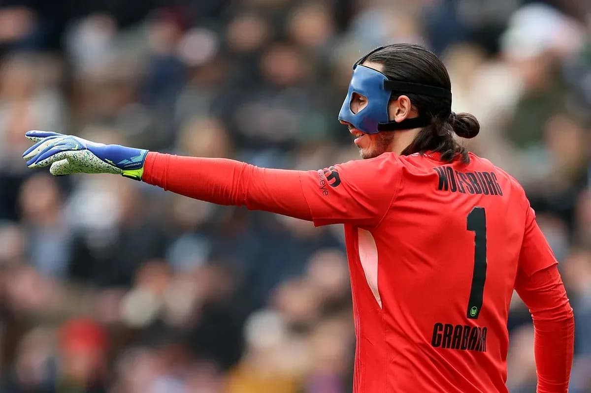 Goalkeeper in red jersey directing play during match Goalkeeper in red jersey directing play during match
