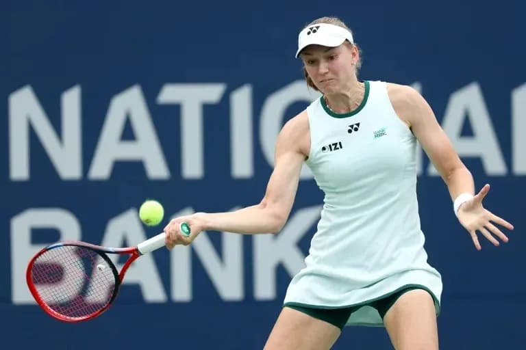 Tennis player hitting a backhand stroke during match Tennis player hitting a backhand stroke during match