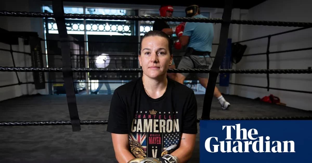 Boxer sitting in ring with training in background Boxer sitting in ring with training in background