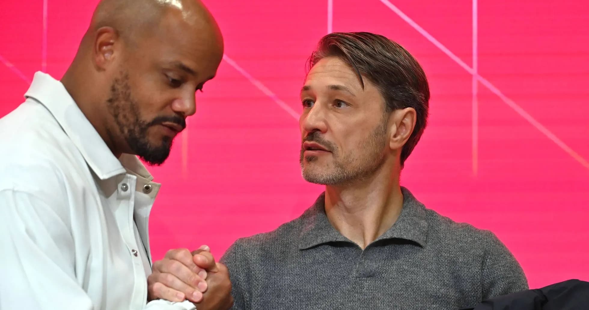 Two men shaking hands at a press conference Two men shaking hands at a press conference