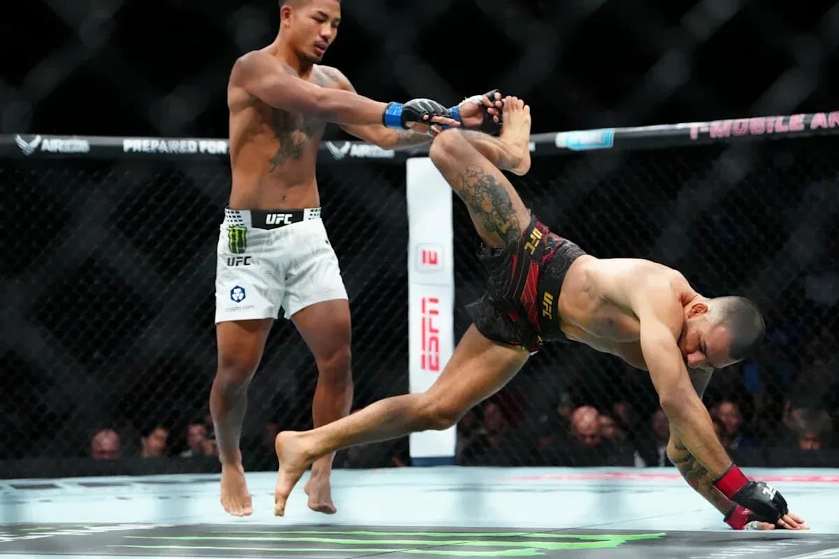 MMA fighters engaged in a grappling maneuver MMA fighters engaged in a grappling maneuver
