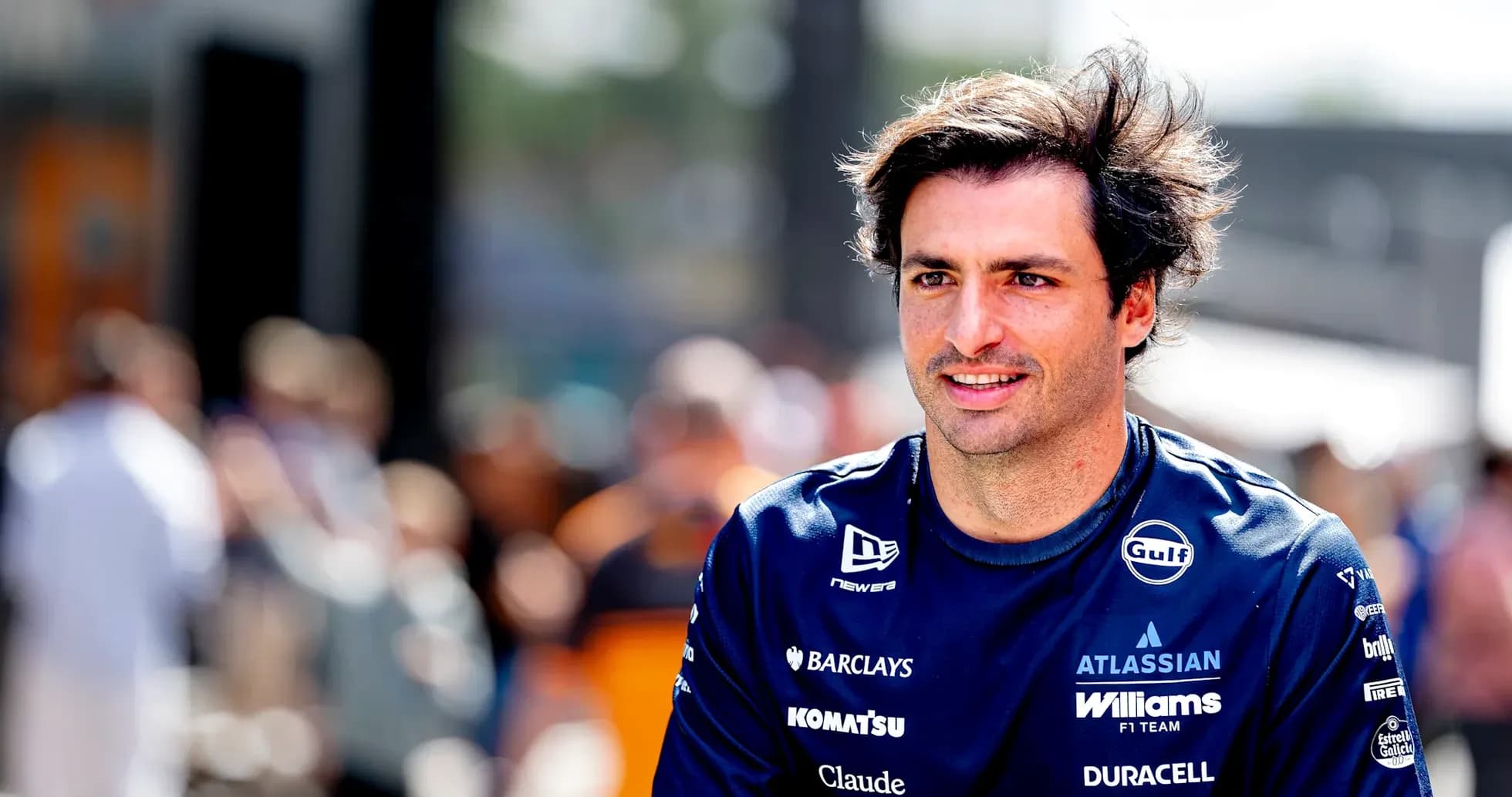 F1 driver in team uniform walking in paddock F1 driver in team uniform walking in paddock
