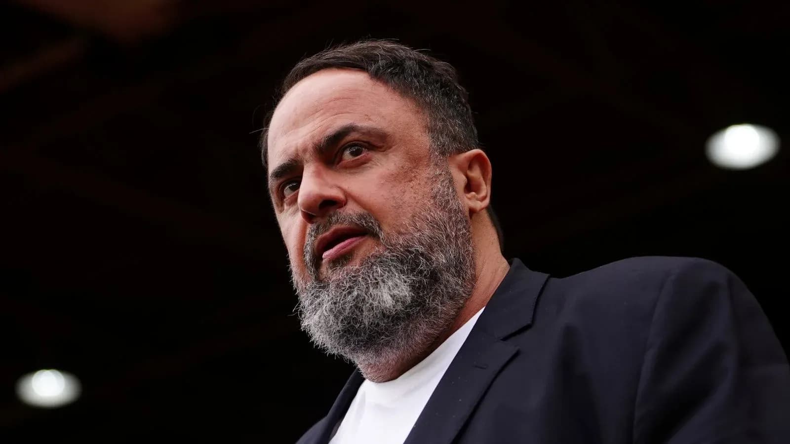 Man with beard speaking at event Man with beard speaking at event