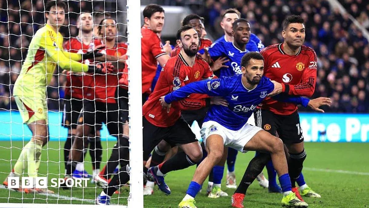 Players from Everton and Manchester United near goalpost Players from Everton and Manchester United near goalpost