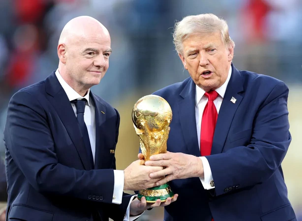 Gianni Infantino and Donald Trump holding World Cup trophy Gianni Infantino and Donald Trump holding World Cup trophy