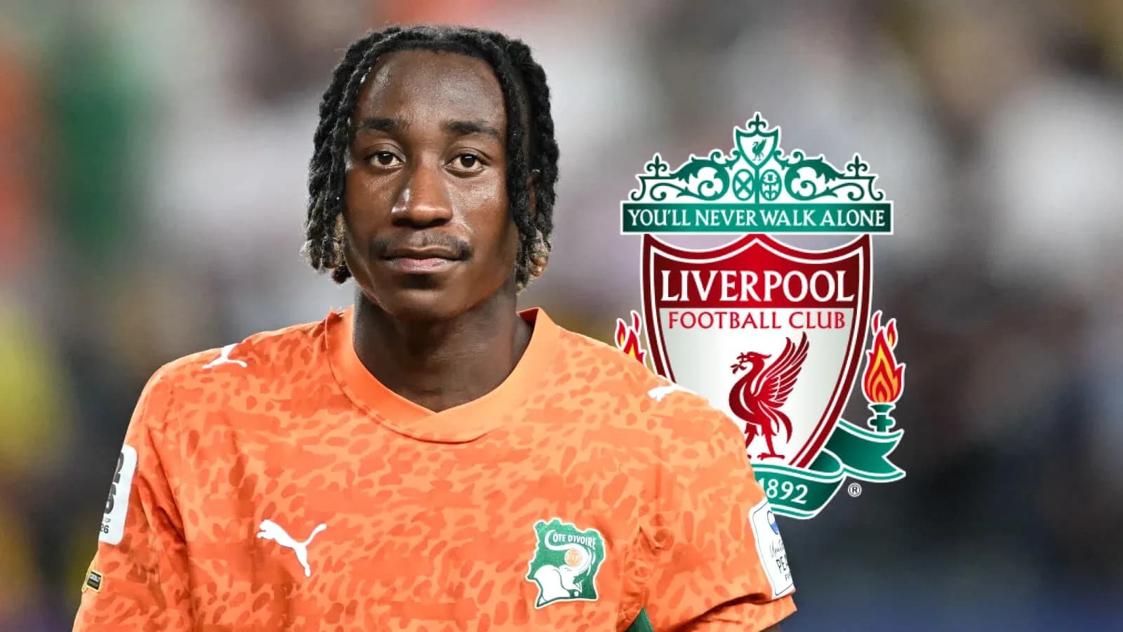 Goalkeeper in orange jersey with Liverpool logo background Goalkeeper in orange jersey with Liverpool logo background