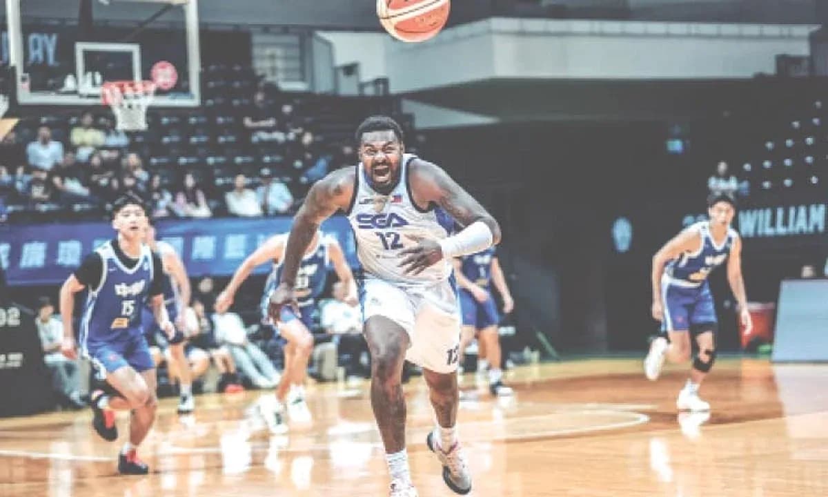 Player 12 sprinting after loose basketball during game Player 12 sprinting after loose basketball during game