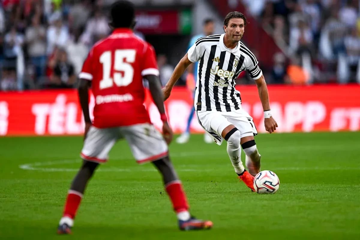 Juventus player dribbling past opponent during match Juventus player dribbling past opponent during match