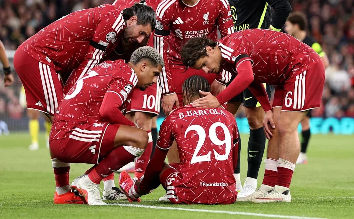 Liverpool players supporting teammate on the ground Liverpool players supporting teammate on the ground