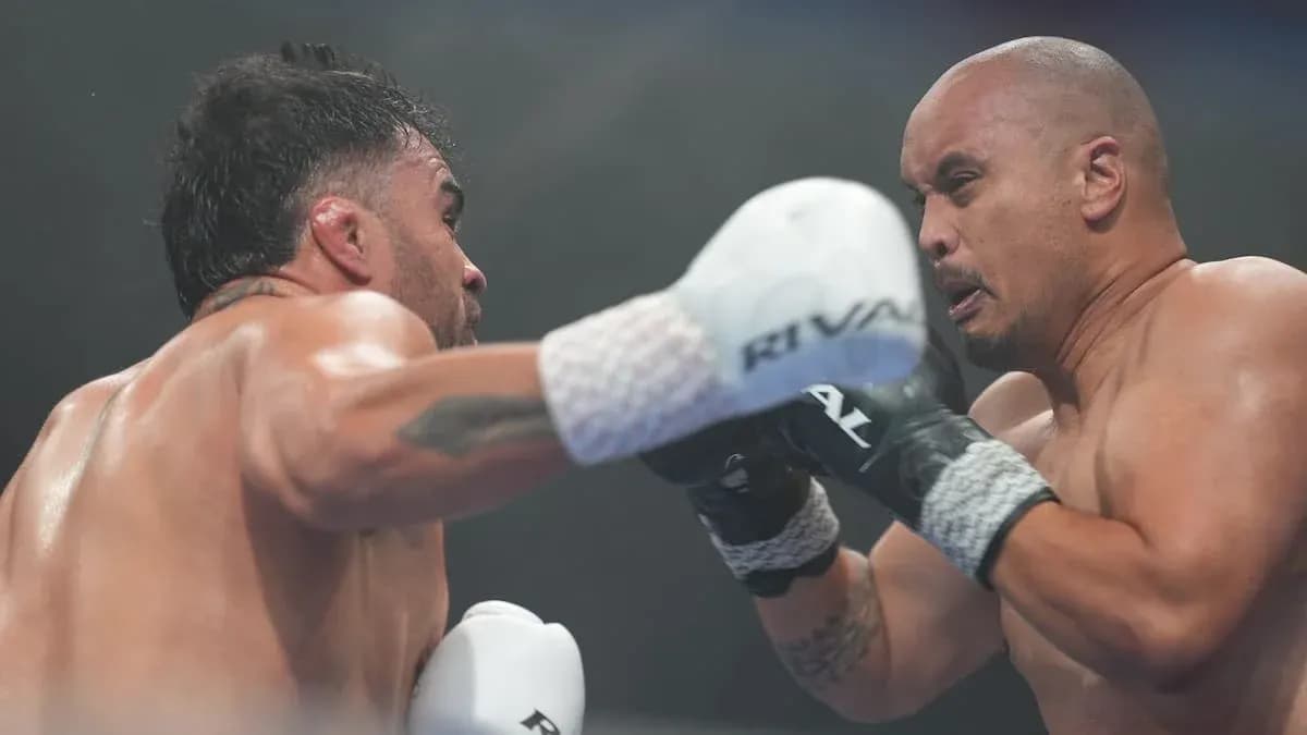 Boxers exchanging punches in a boxing match Boxers exchanging punches in a boxing match