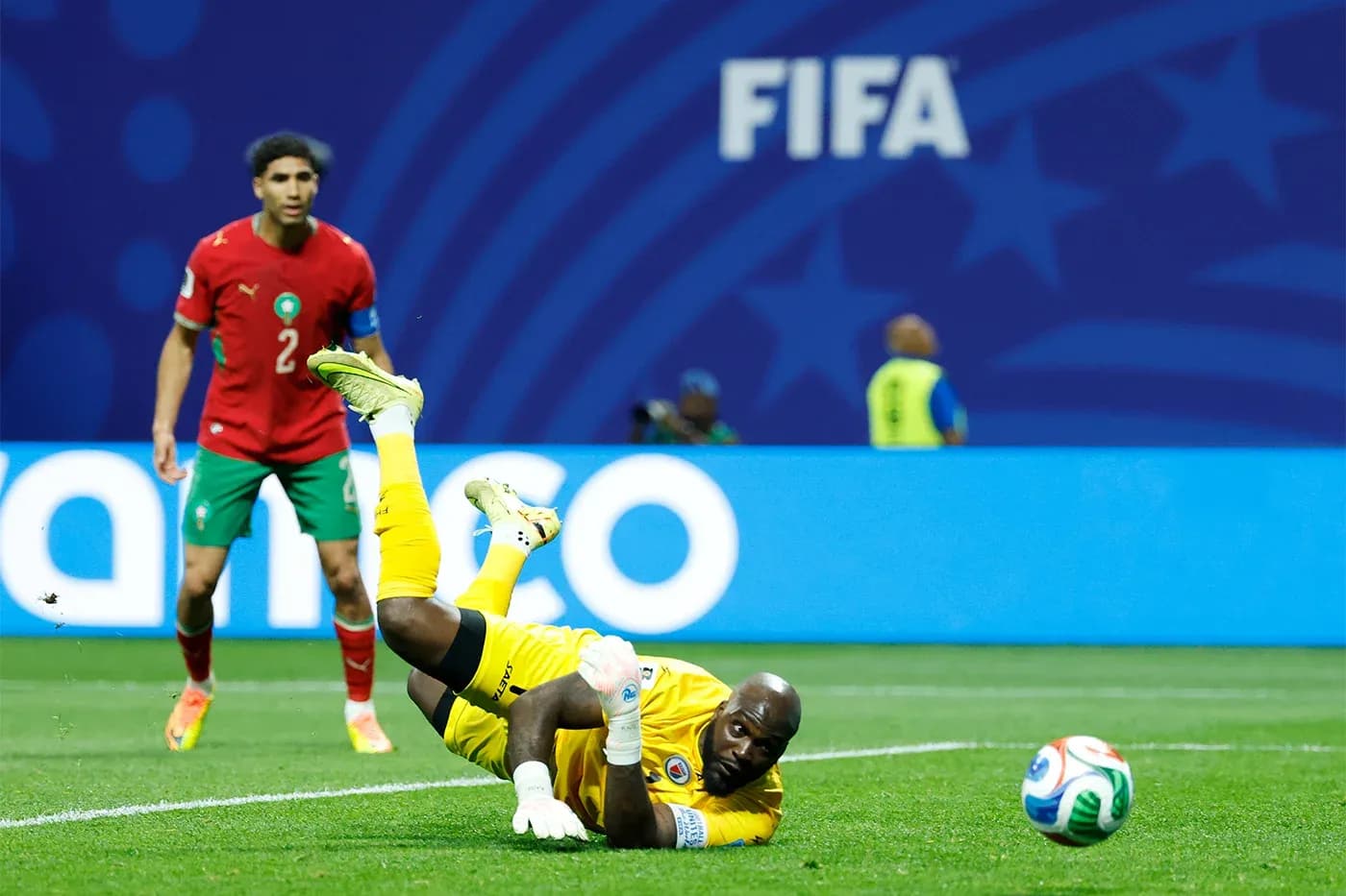 Goalkeeper diving for the ball during a match Goalkeeper diving for the ball during a match