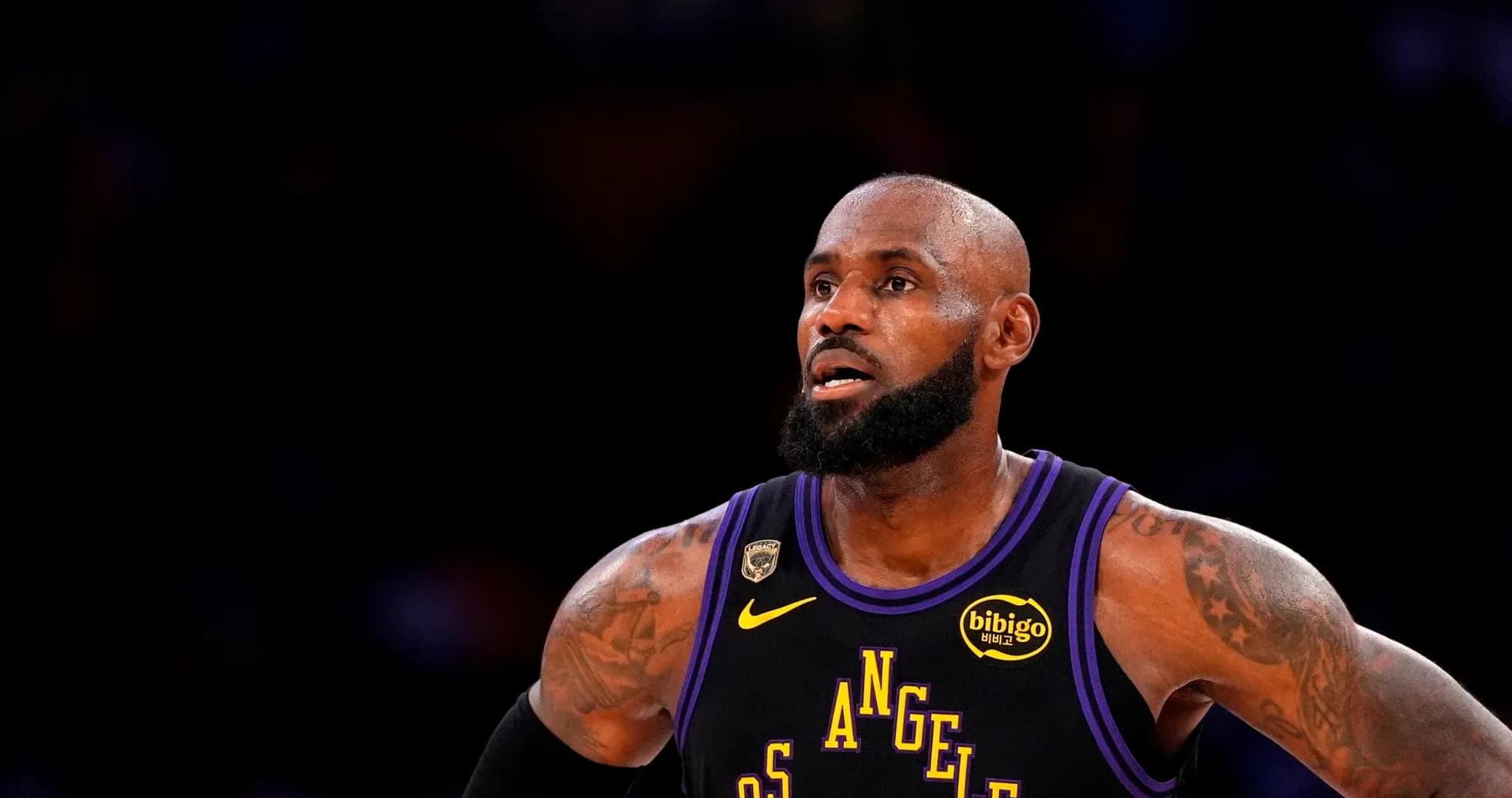 Basketball player in Los Angeles Lakers jersey on court Basketball player in Los Angeles Lakers jersey on court