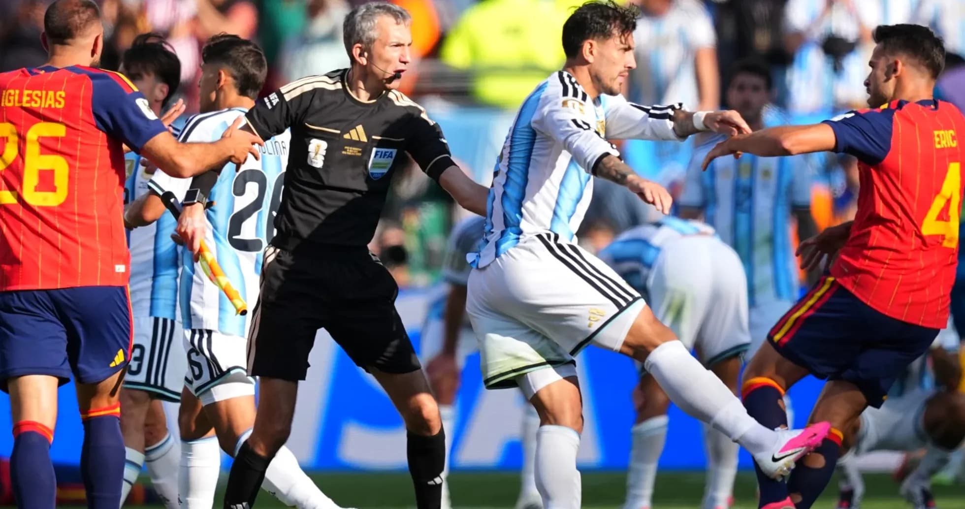 Players clashing during match with referee intervening Players clashing during match with referee intervening