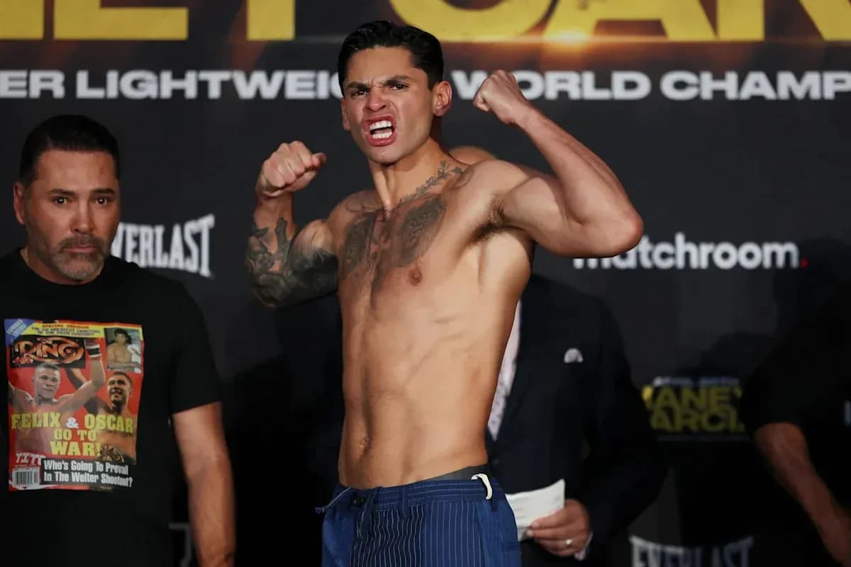 Boxer flexing muscles at weigh-in event Boxer flexing muscles at weigh-in event