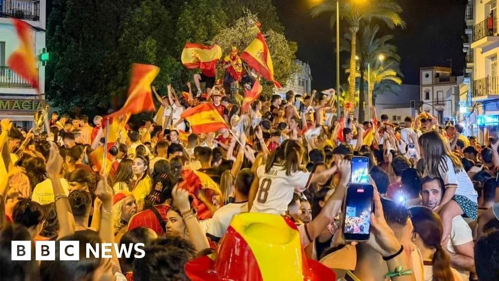 Celebration with fans waving Spanish flags at night Celebration with fans waving Spanish flags at night