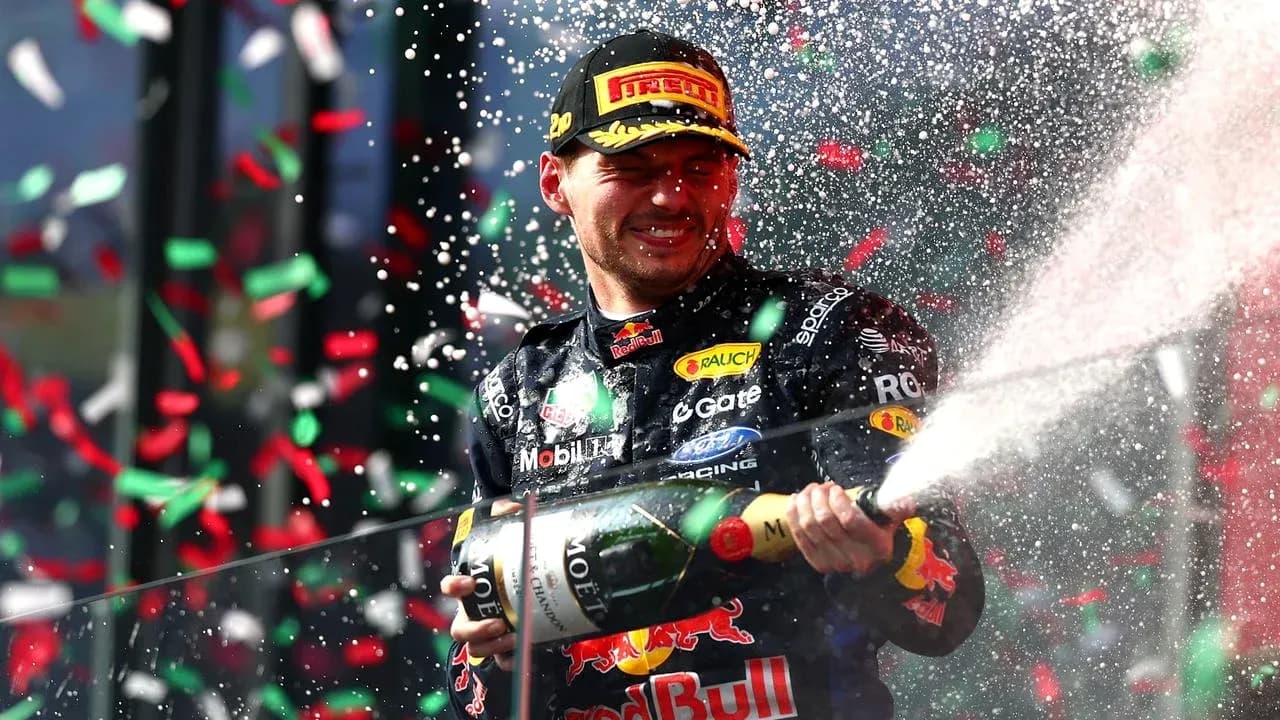 Max Verstappen celebrating with champagne on podium Max Verstappen celebrating with champagne on podium