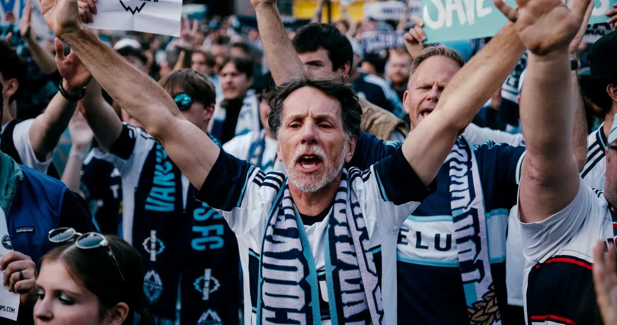 Vancouver Whitecaps fans cheering with signs Vancouver Whitecaps fans cheering with signs