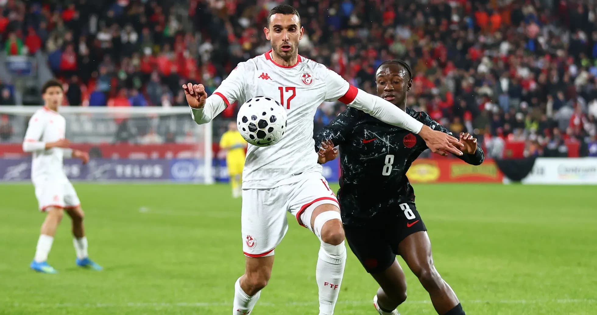 Tunisian player controlling ball during match against Canada Tunisian player controlling ball during match against Canada