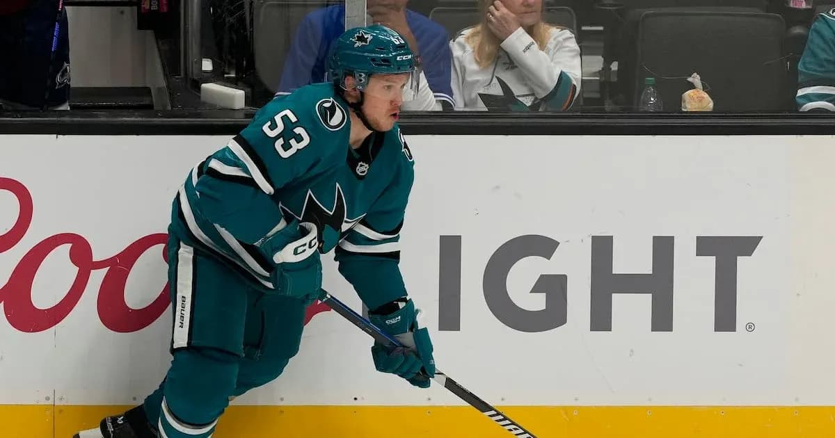Hockey player in teal jersey during game action Hockey player in teal jersey during game action