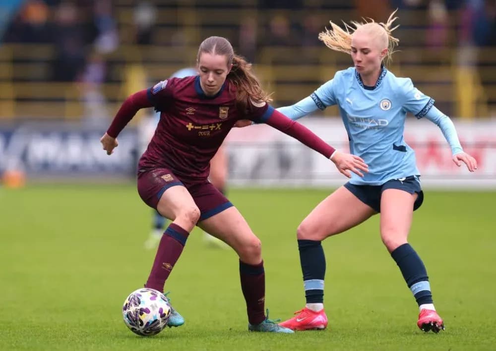 Two female players competing for the ball Two female players competing for the ball
