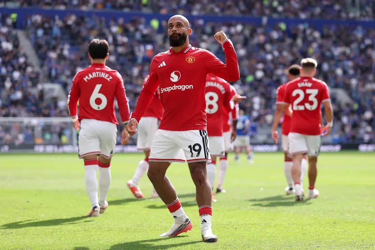 Manchester United player celebrating a goal on pitch Manchester United player celebrating a goal on pitch