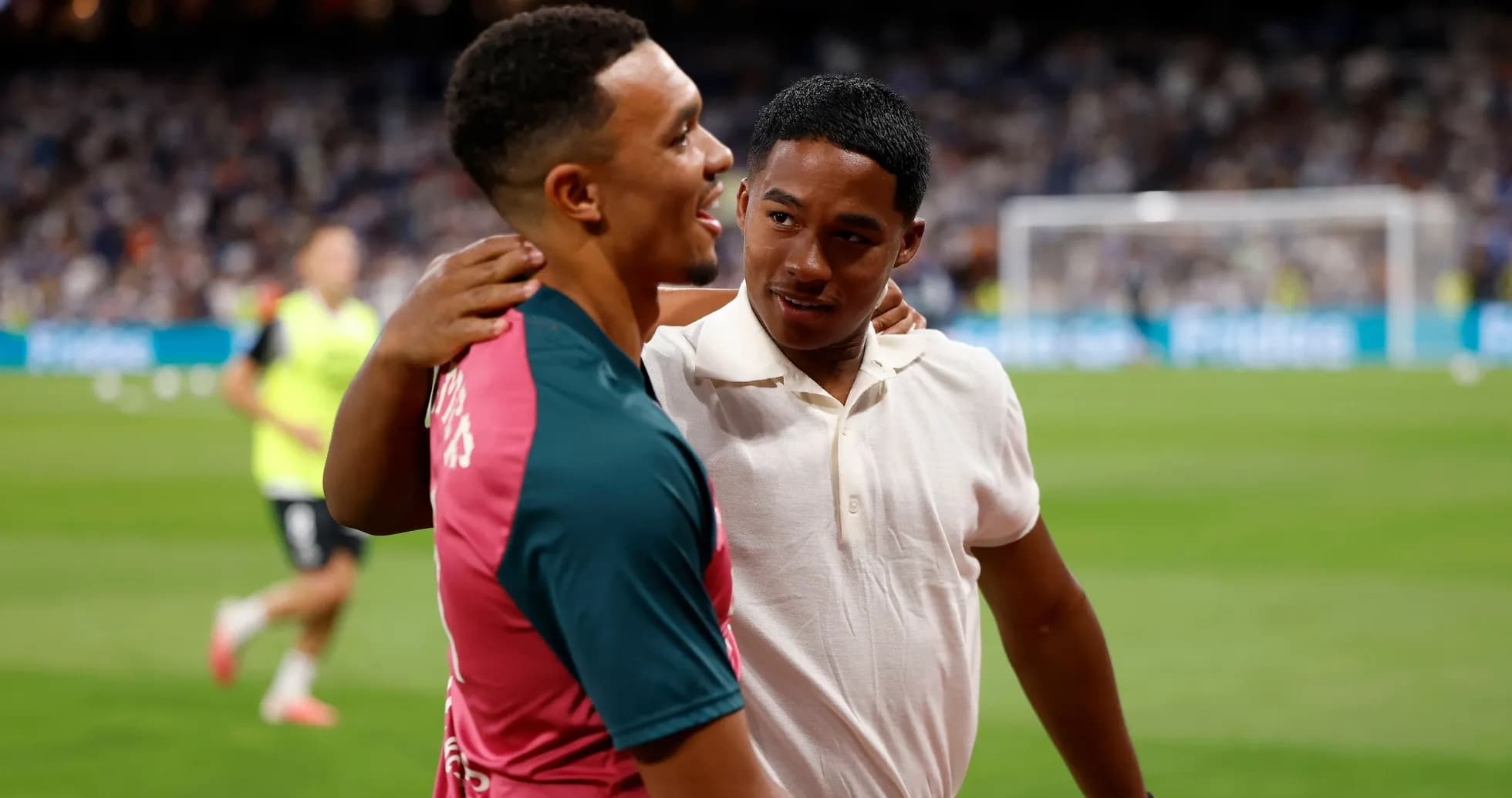Two players interacting on the field before a match Two players interacting on the field before a match