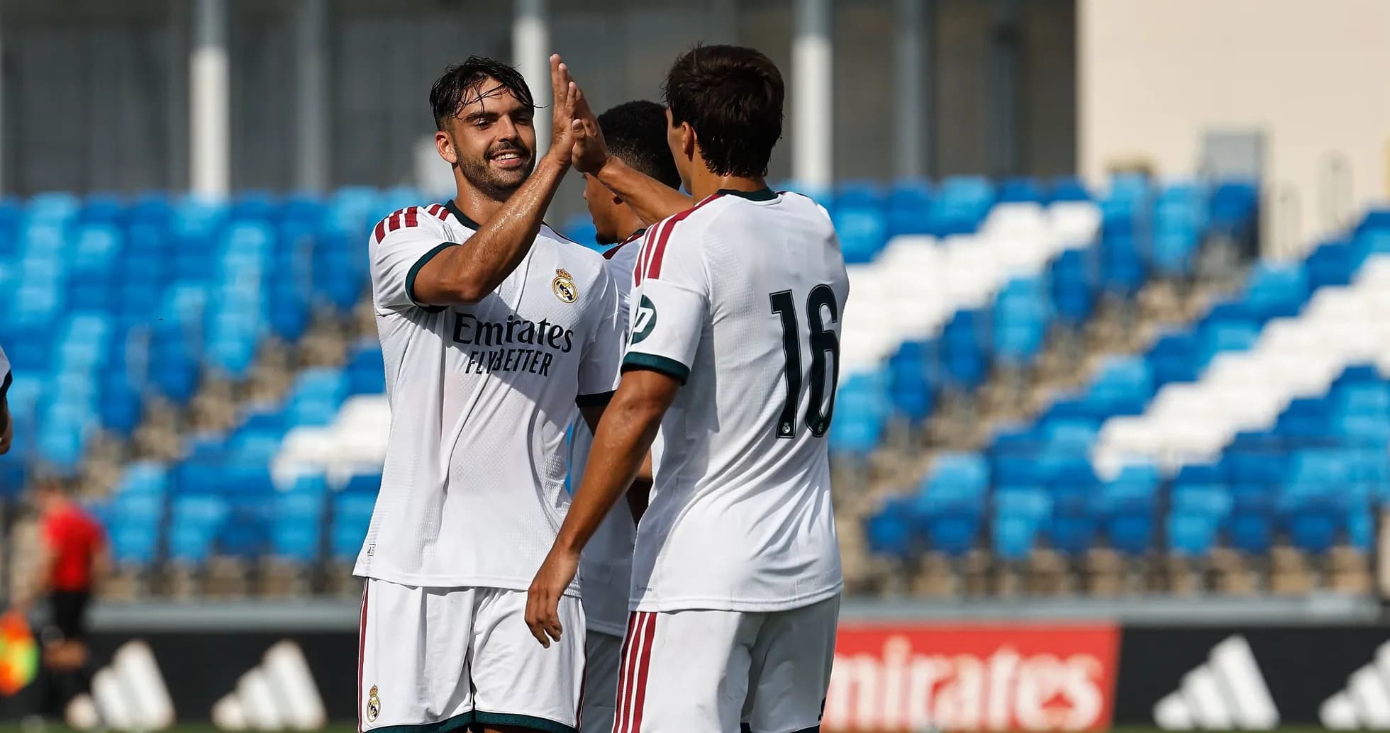 Real Madrid players celebrating a goal on field Real Madrid players celebrating a goal on field