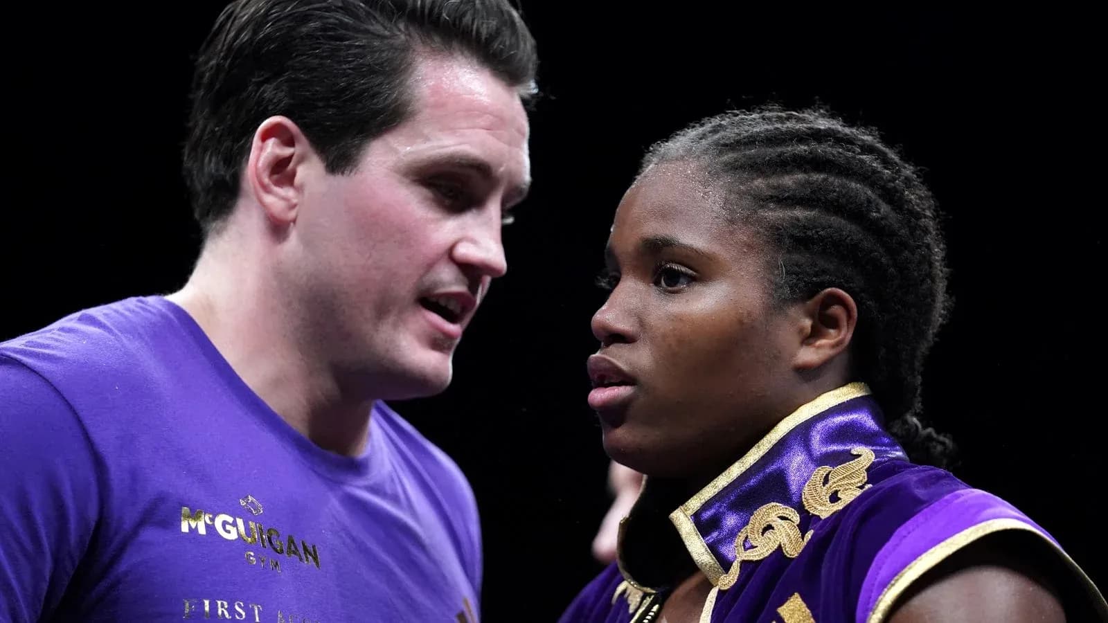 Boxer receiving instructions from coach before match Boxer receiving instructions from coach before match