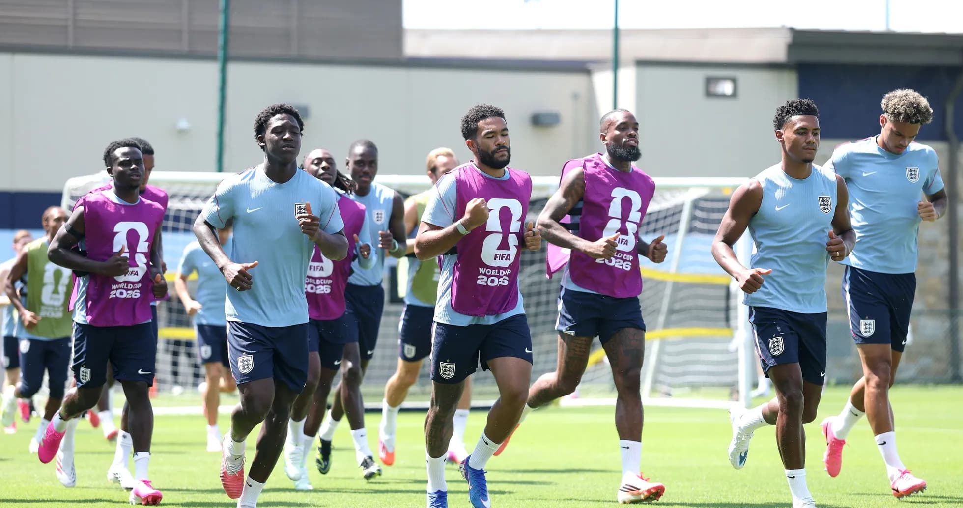 England team running during training session on pitch England team running during training session on pitch