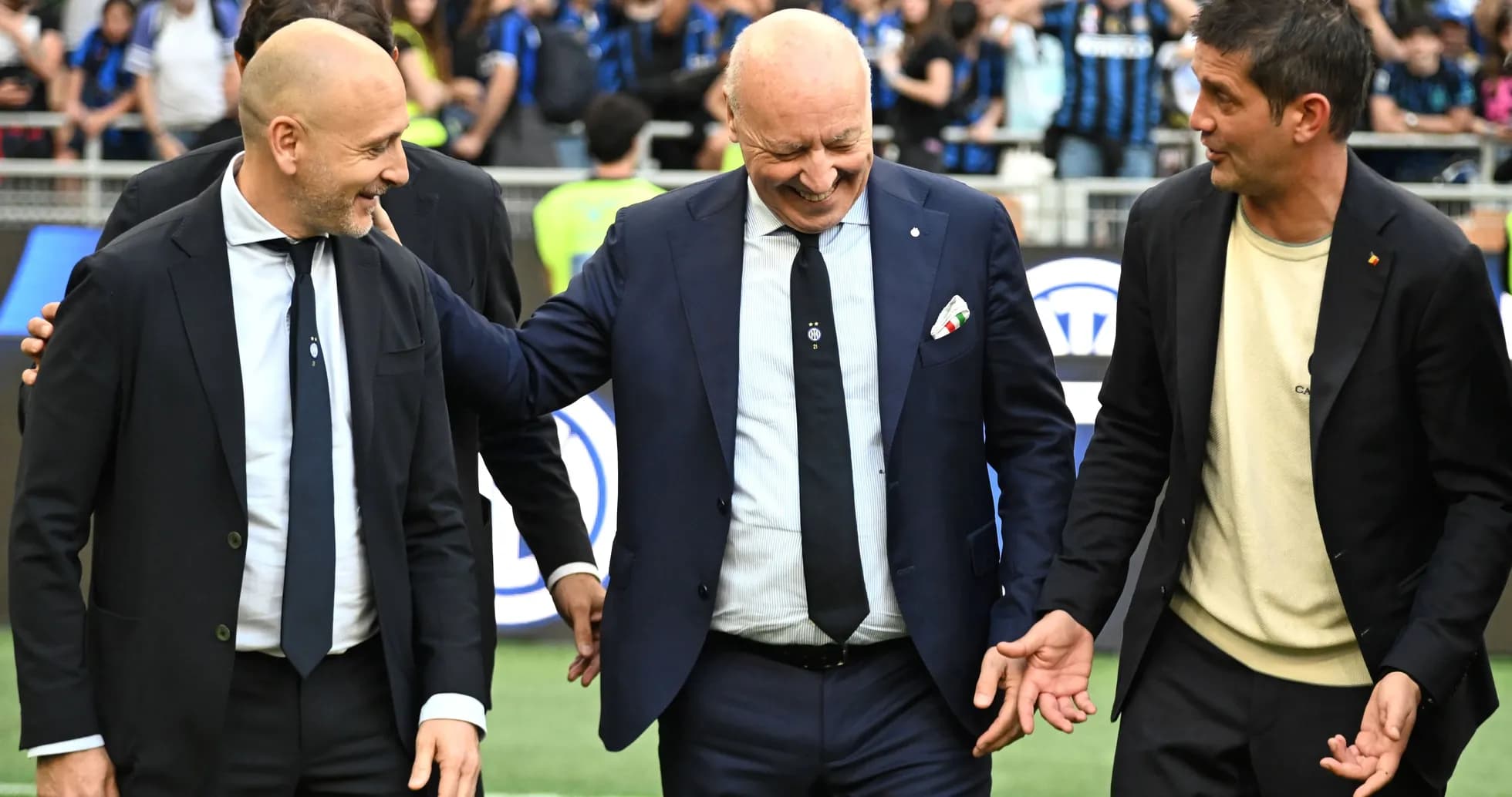 Coaches interacting on the pitch before a match Coaches interacting on the pitch before a match