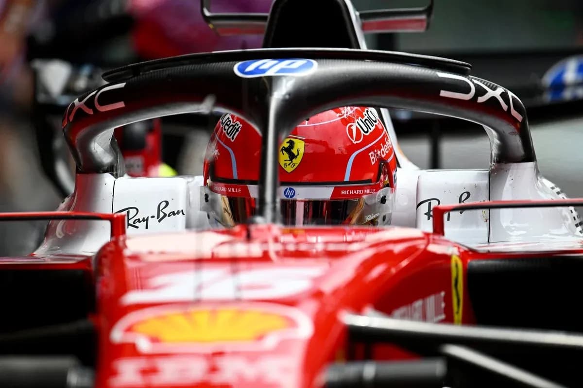 F1 driver in Ferrari car during race preparation F1 driver in Ferrari car during race preparation