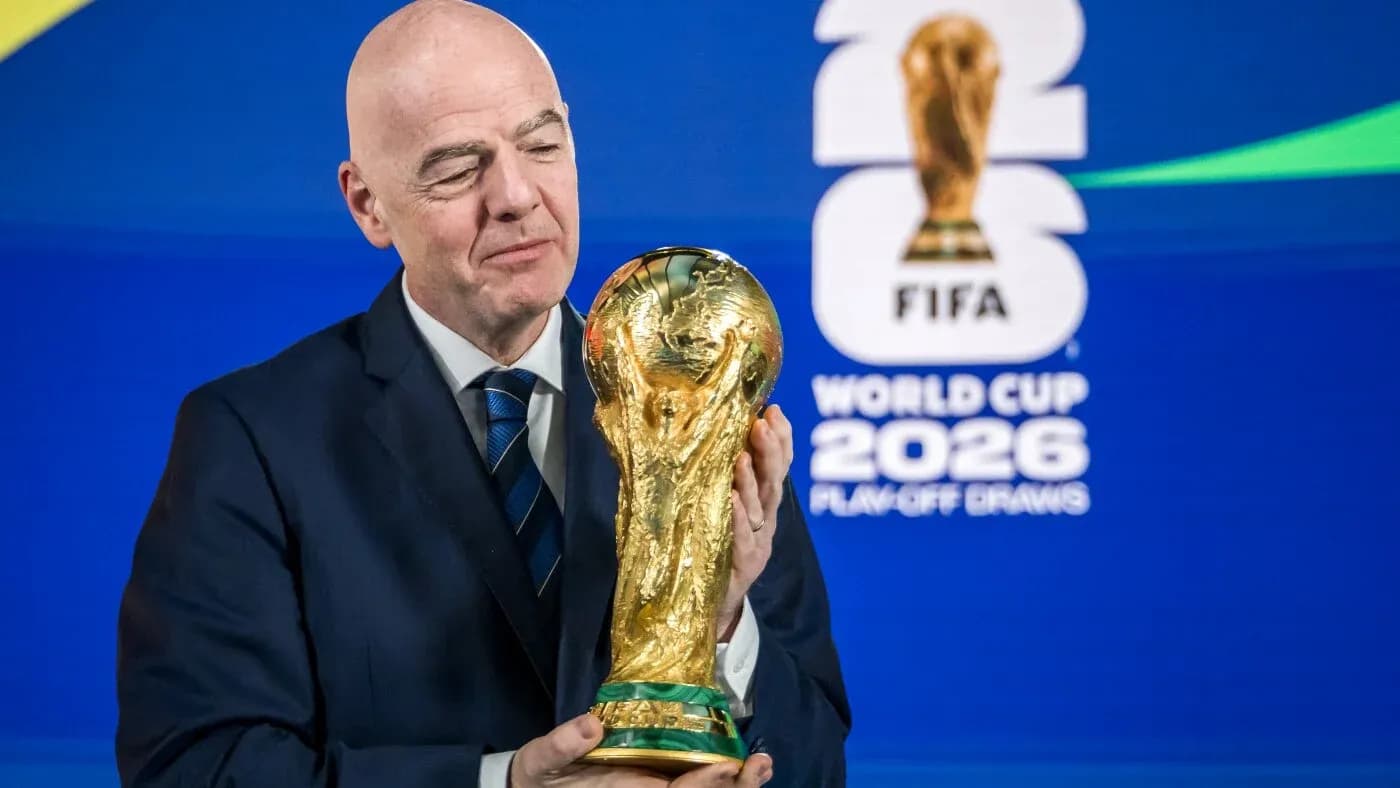 FIFA president holding World Cup trophy at event FIFA president holding World Cup trophy at event