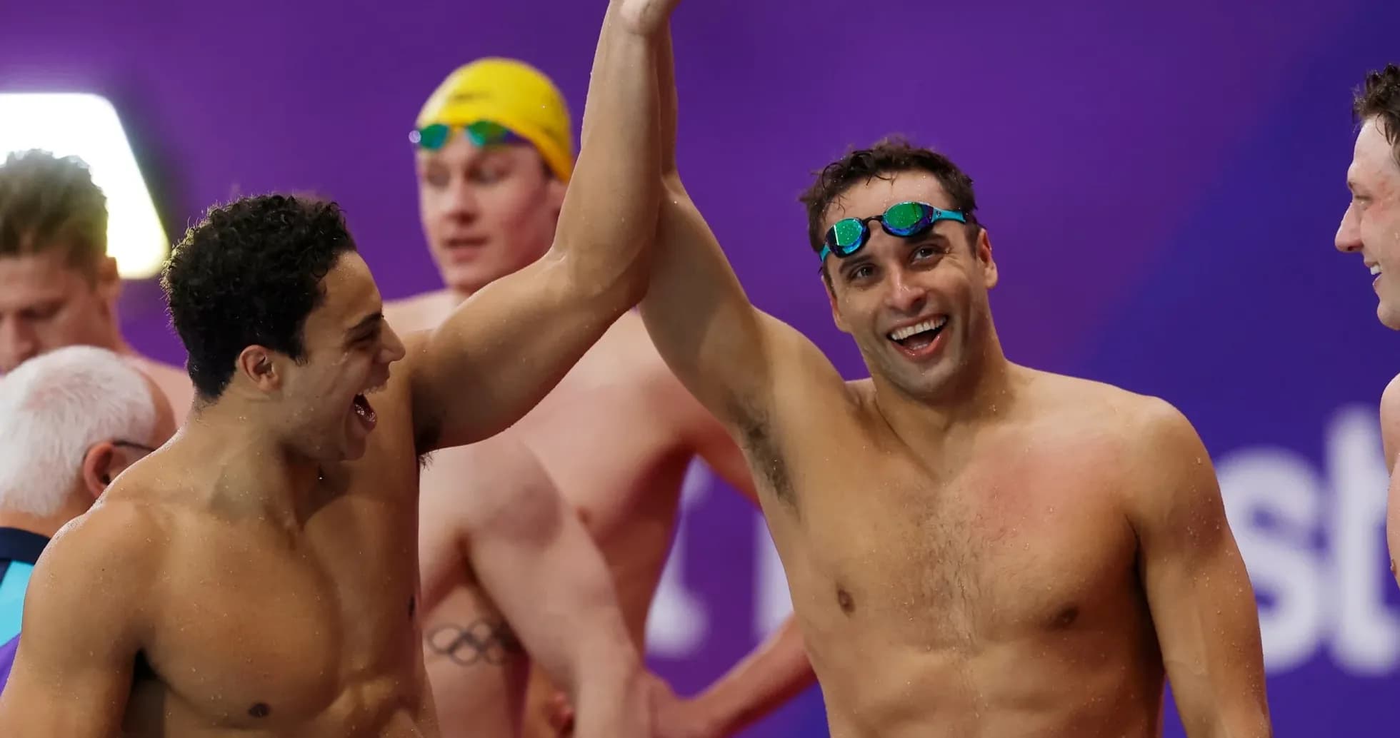 Two swimmers celebrating after a competition Two swimmers celebrating after a competition