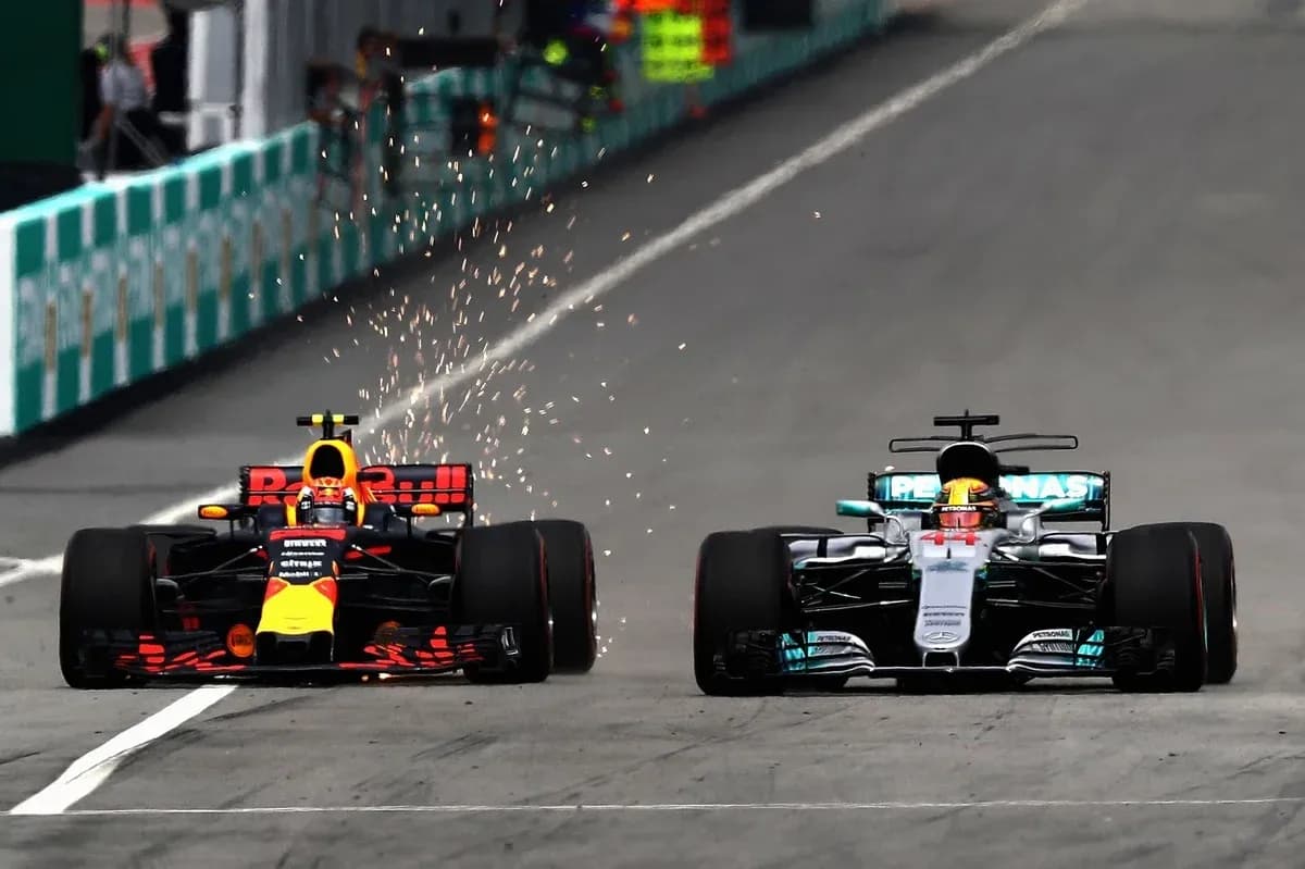 Red Bull and Mercedes cars racing closely on track Red Bull and Mercedes cars racing closely on track