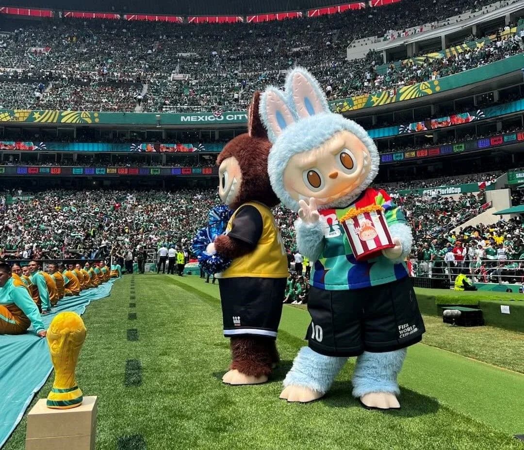 Two mascots on field during World Cup event Two mascots on field during World Cup event