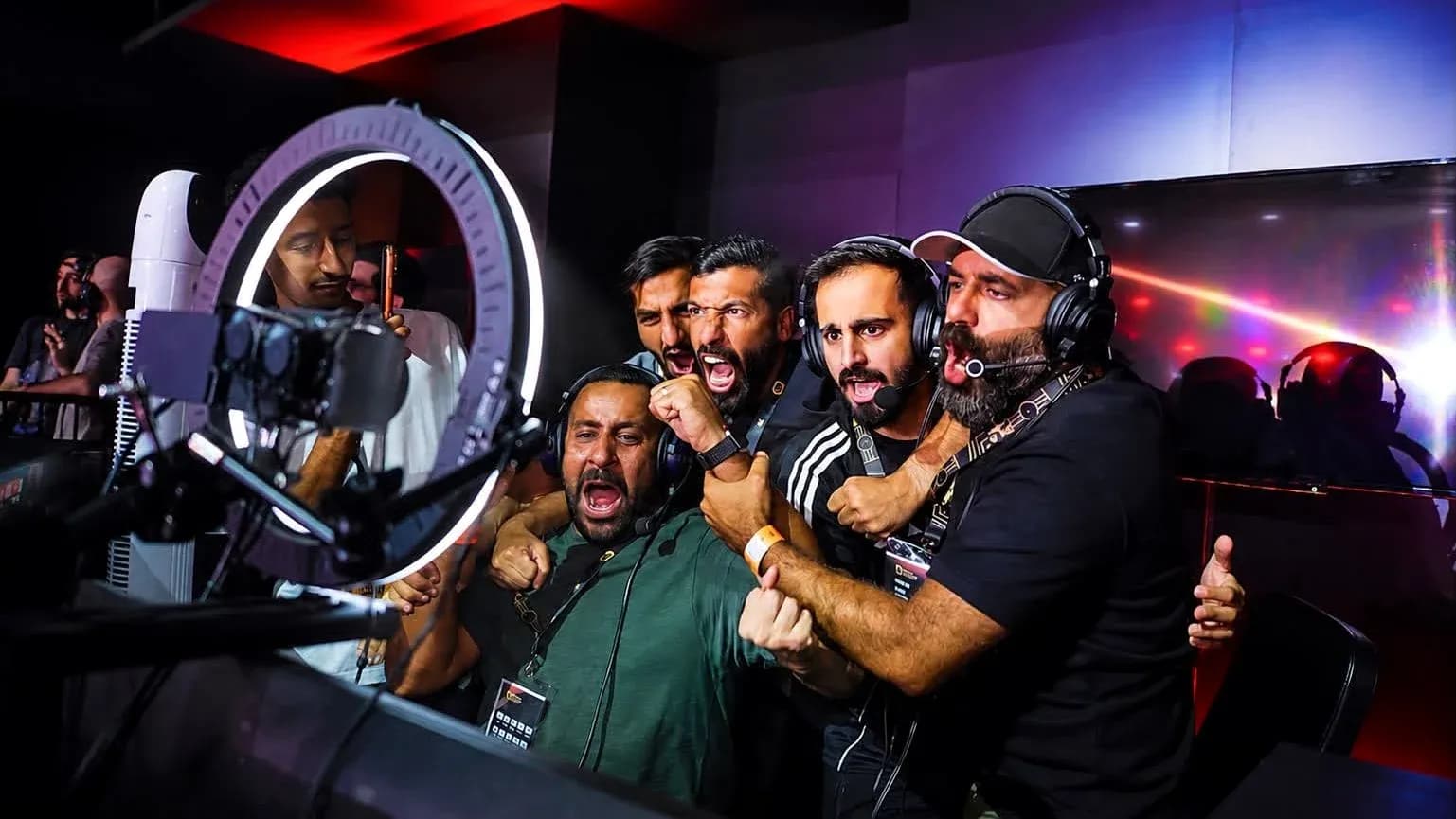 Commentators celebrating during an esports event Commentators celebrating during an esports event